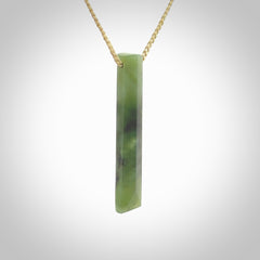 This photo shows a large Totoweka jade drop shaped pendant. It a a lovely, semi-translucent jade. The cord is tan and is adjustable in length. One only large, contemporary drop necklace from New Zealand Totoweka Jade, by Rueben Tipene.