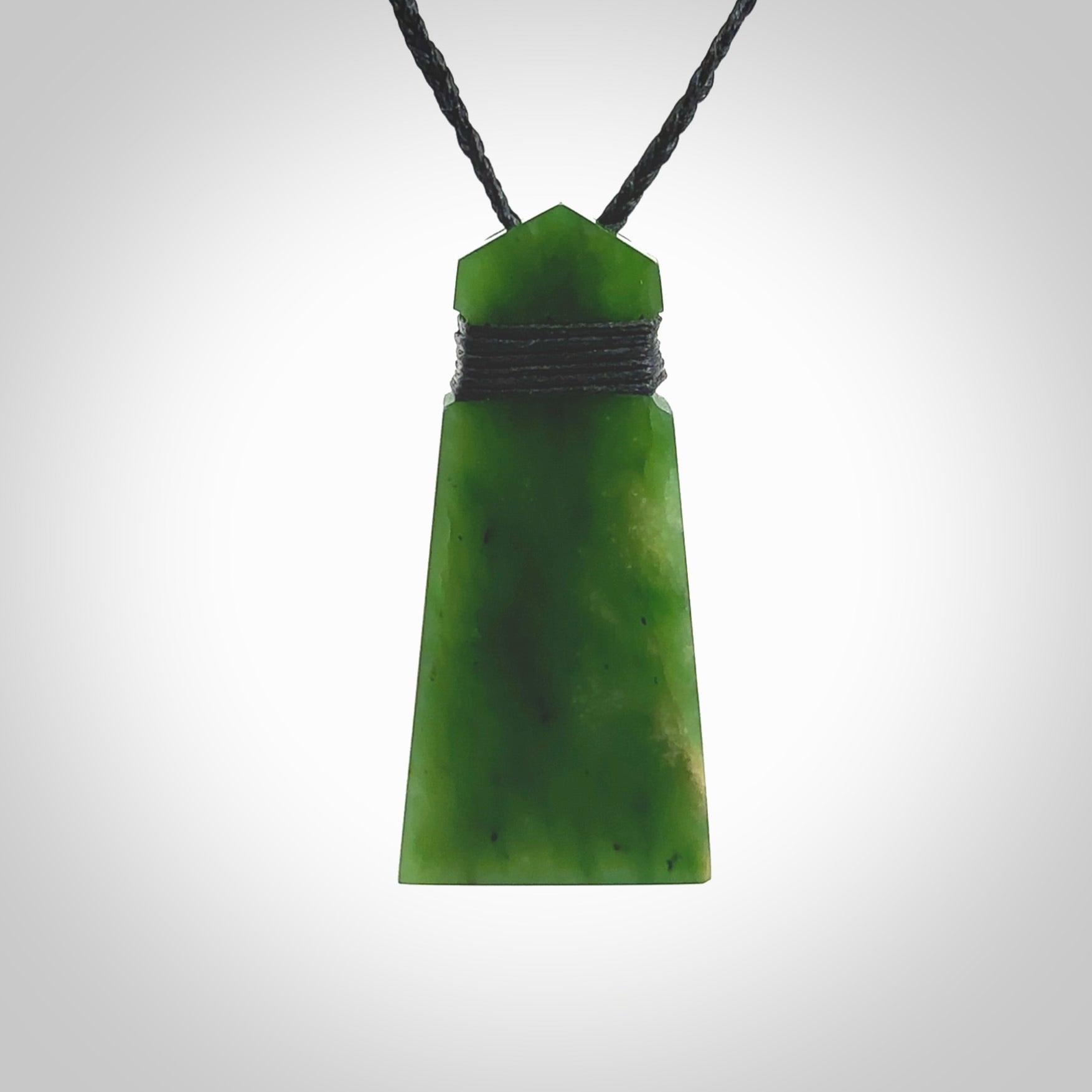 Hand made large New Zealand Kawakawa jade toki pendant. Hand carved in New Zealand by Rueben Tipene. Hand made jewellery. Unique large Jade Toki with adjustable cord. Free shipping worldwide.