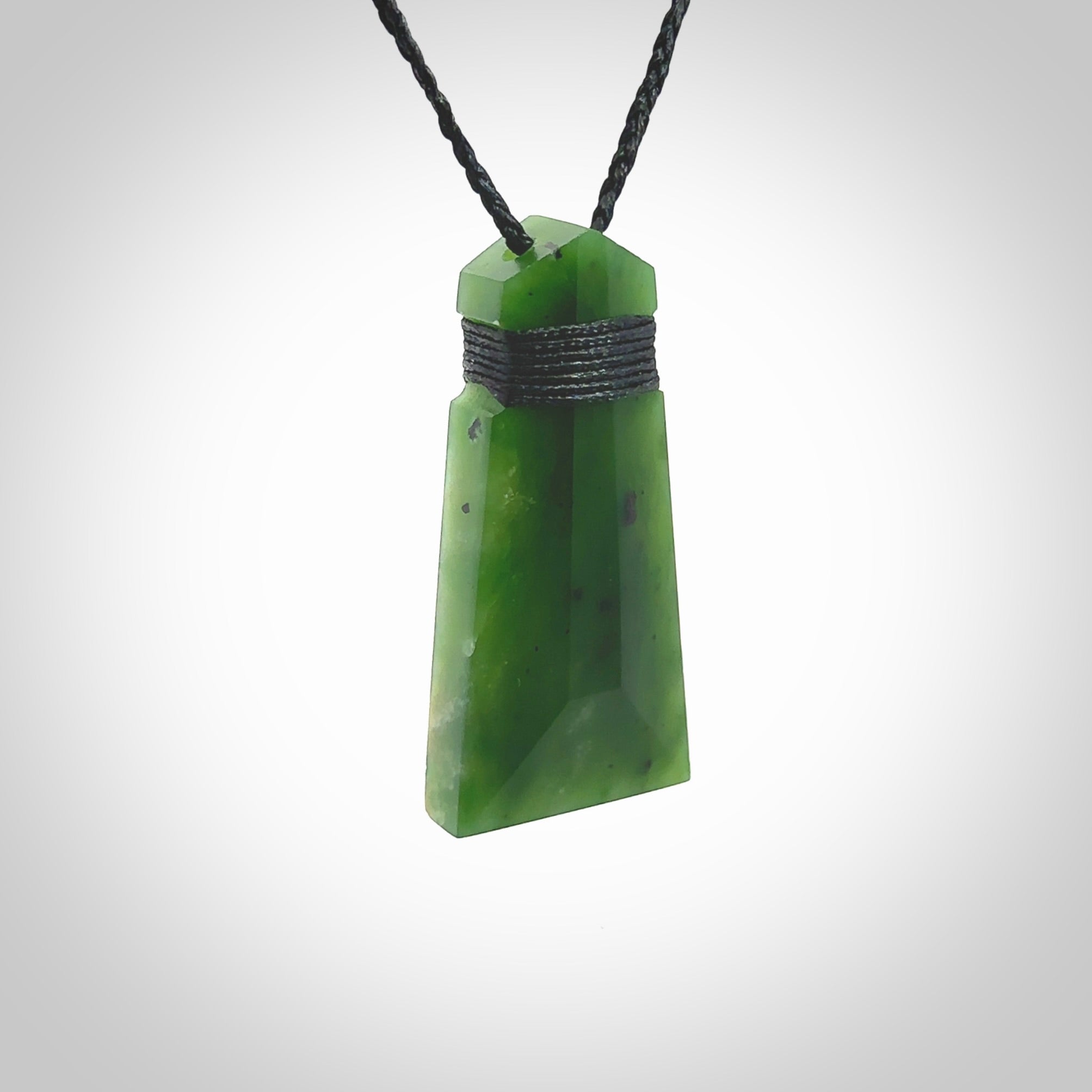 Hand made large New Zealand Kawakawa jade toki pendant. Hand carved in New Zealand by Rueben Tipene. Hand made jewellery. Unique large Jade Toki with adjustable cord. Free shipping worldwide.