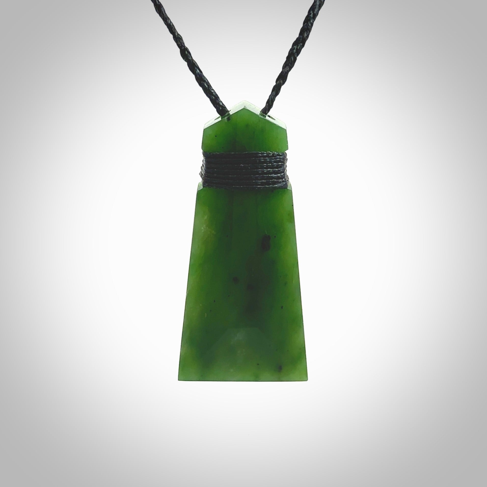 Hand made large New Zealand Kawakawa jade toki pendant. Hand carved in New Zealand by Rueben Tipene. Hand made jewellery. Unique large Jade Toki with adjustable cord. Free shipping worldwide.