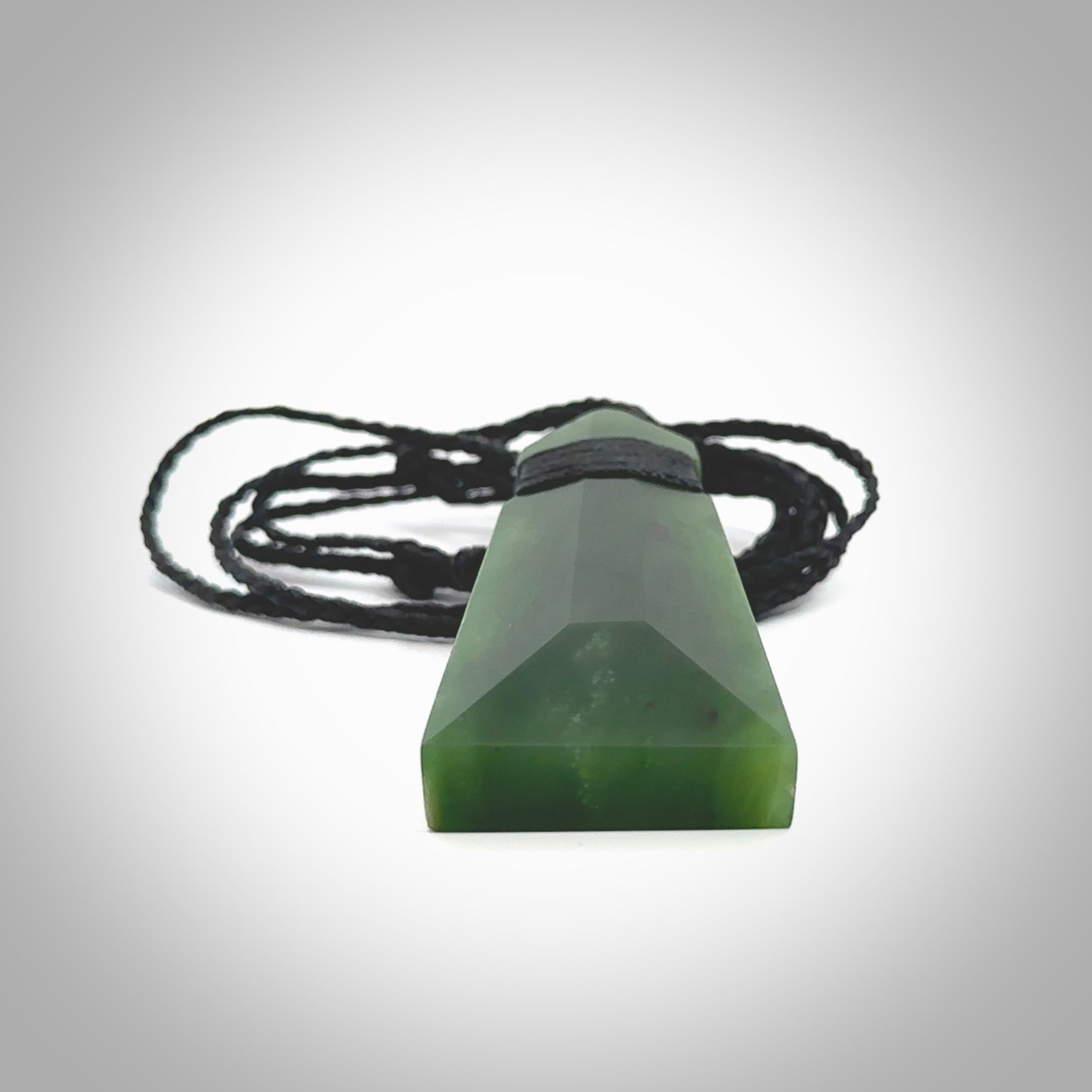 Hand made large New Zealand Kawakawa jade toki pendant. Hand carved in New Zealand by Rueben Tipene. Hand made jewellery. Unique large Jade Toki with adjustable cord. Free shipping worldwide.