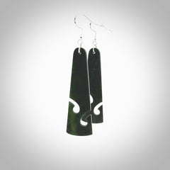 Hand carved by Rueben Tipene, these lovely koru jade earrings are hand made and an absolute delight. One pair only, postage is included in the price. Delivered to you in a woven kete pouch. New Zealand Jade drop earrings with koru.