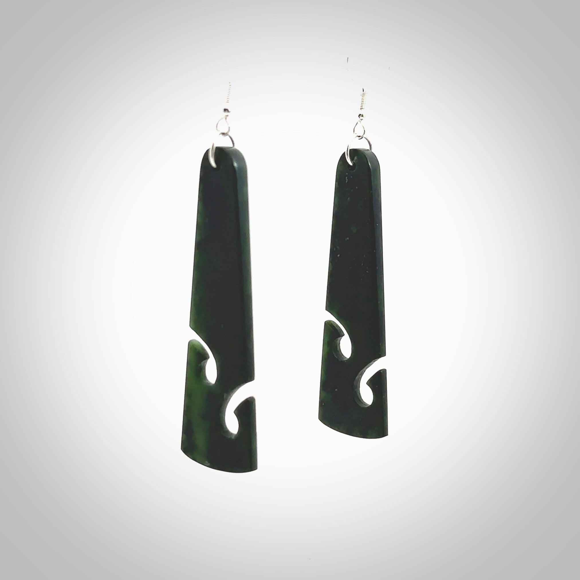 Hand carved by Rueben Tipene, these lovely koru jade earrings are hand made and an absolute delight. One pair only, postage is included in the price. Delivered to you in a woven kete pouch. New Zealand Jade drop earrings with koru.