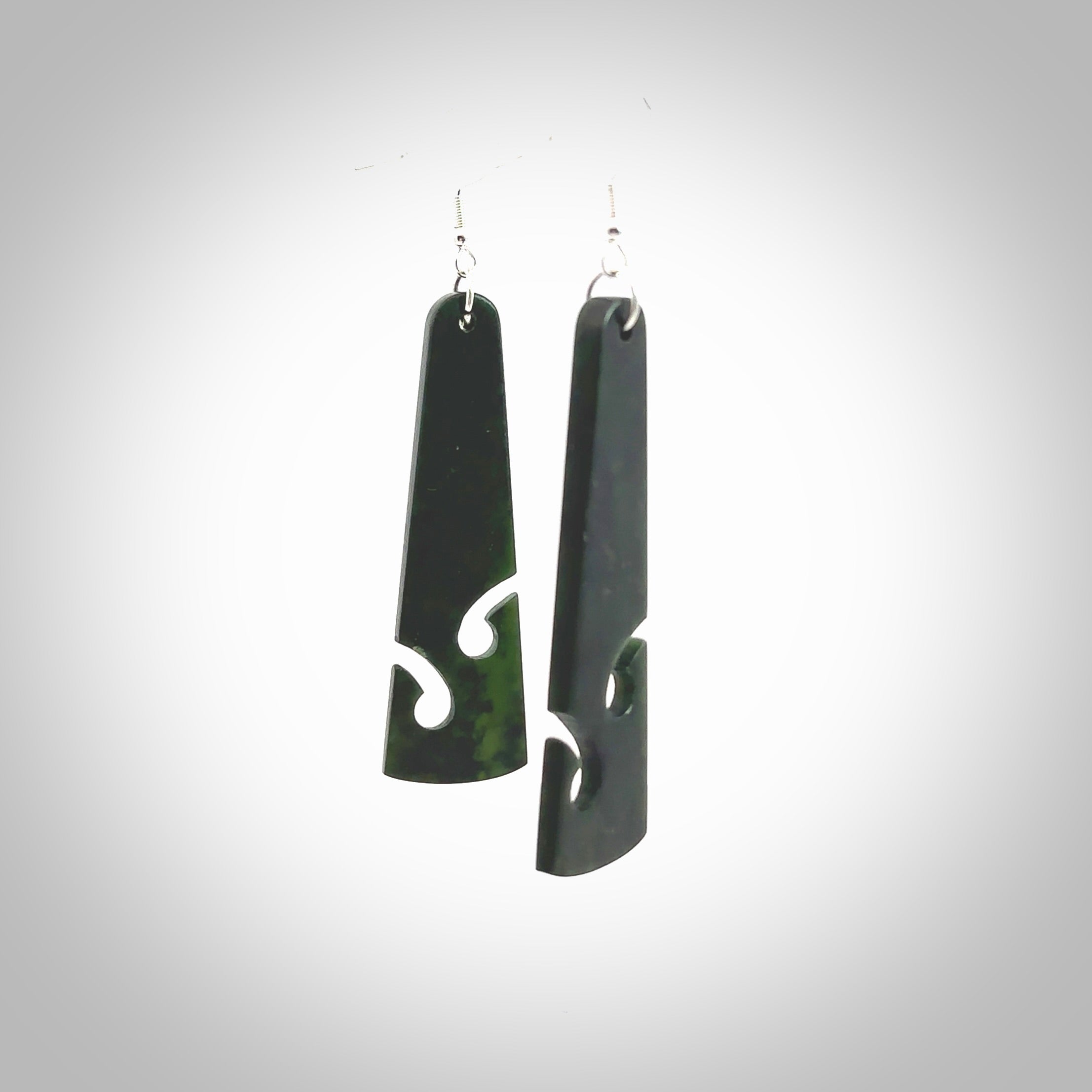 Hand carved by Rueben Tipene, these lovely koru jade earrings are hand made and an absolute delight. One pair only, postage is included in the price. Delivered to you in a woven kete pouch. New Zealand Jade drop earrings with koru.