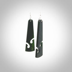 Hand carved by Rueben Tipene, these lovely koru jade earrings are hand made and an absolute delight. One pair only, postage is included in the price. Delivered to you in a woven kete pouch. New Zealand Jade drop earrings with koru.