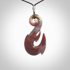 Large hook design pendant carved in Red Agate. Real Agate jewellery for sale online with NZ Pacific. Large hook pendant hand made in red agate, provided with adjustable cord and packaged in a woven kete pouch.