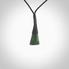 A lovely small sized New Zealand jade drop pendant. This piece is made from a wonderful deep green colour. Carved by Ric Moor for NZ Pacific and delivered worldwide. Provided with an adjustable black cord.