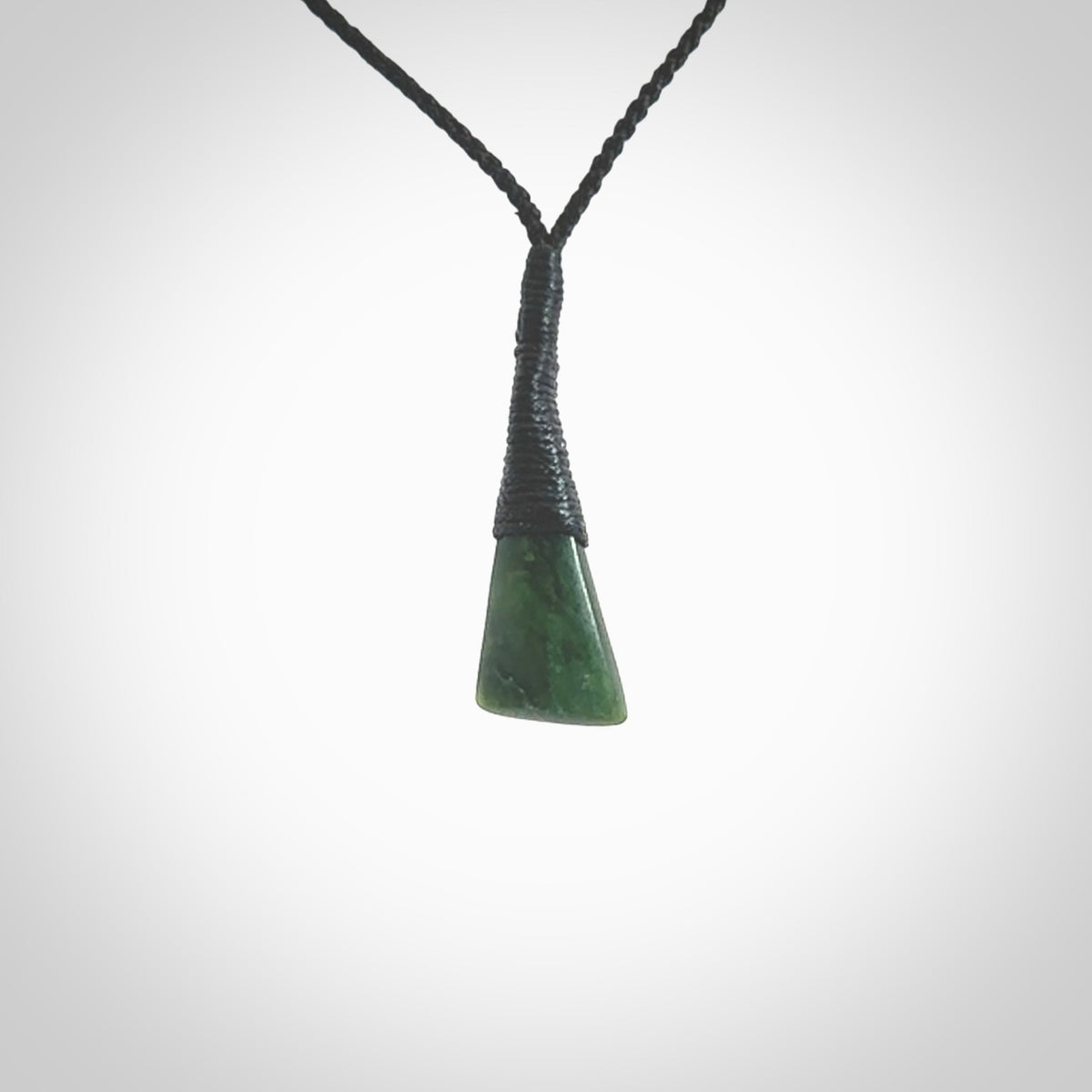 A lovely small sized New Zealand jade drop pendant. This piece is made from a wonderful deep green colour. Carved by Ric Moor for NZ Pacific and delivered worldwide. Provided with an adjustable black cord.