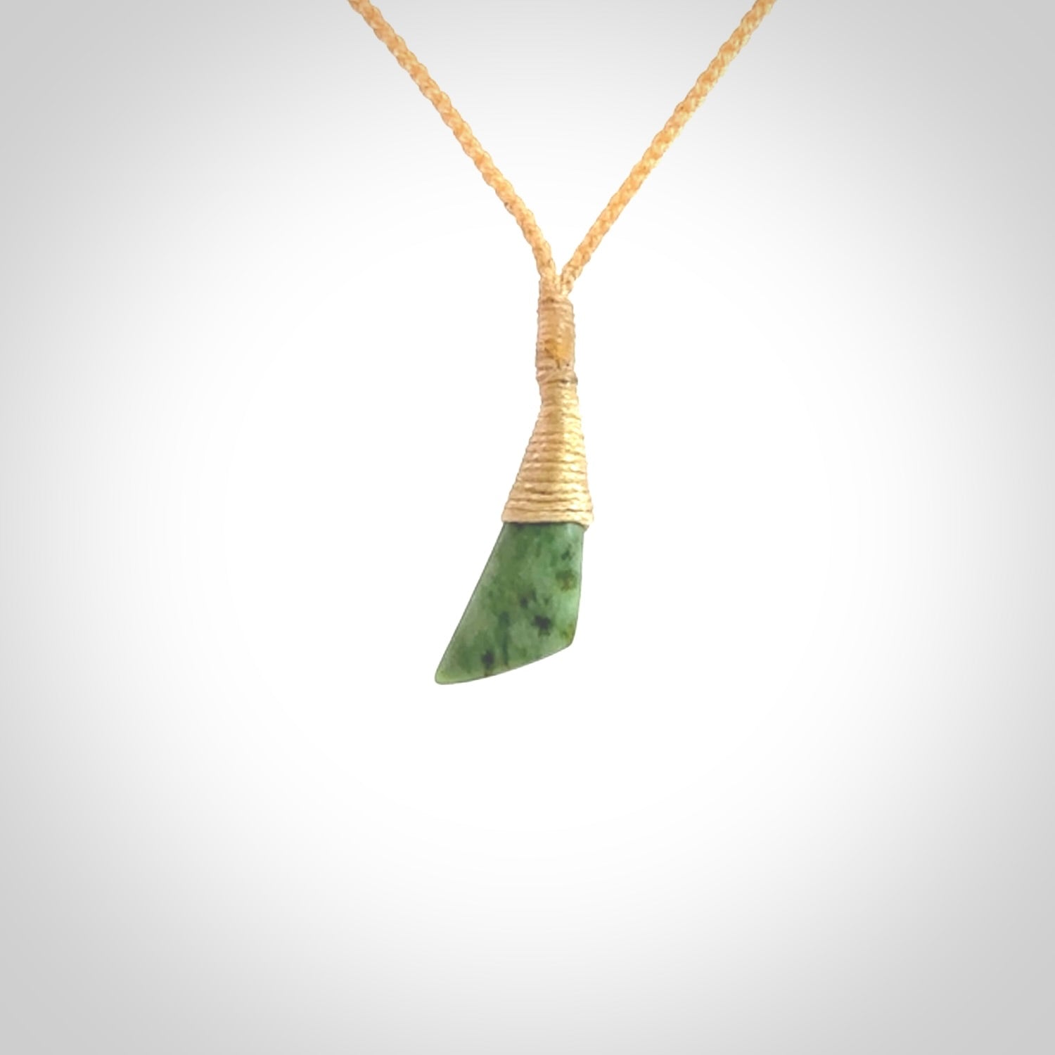 A lovely small sized New Zealand jade drop pendant. This piece is made from a light, green jade. Carved by Ric Moor for NZ Pacific and delivered worldwide. Delivered with adjustable beige cord.