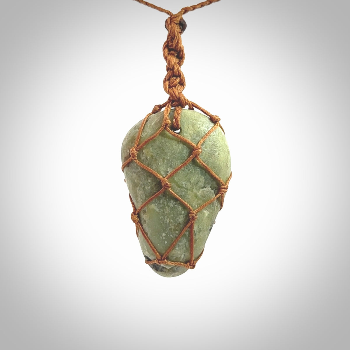 Hand made large New Zealand jade boulder pendant. Hand carved in New Zealand by Ric Moor. Hand made jewellery. Unique large Jade boulder pendant with adjustable length brown coloured cord. Free shipping worldwide.