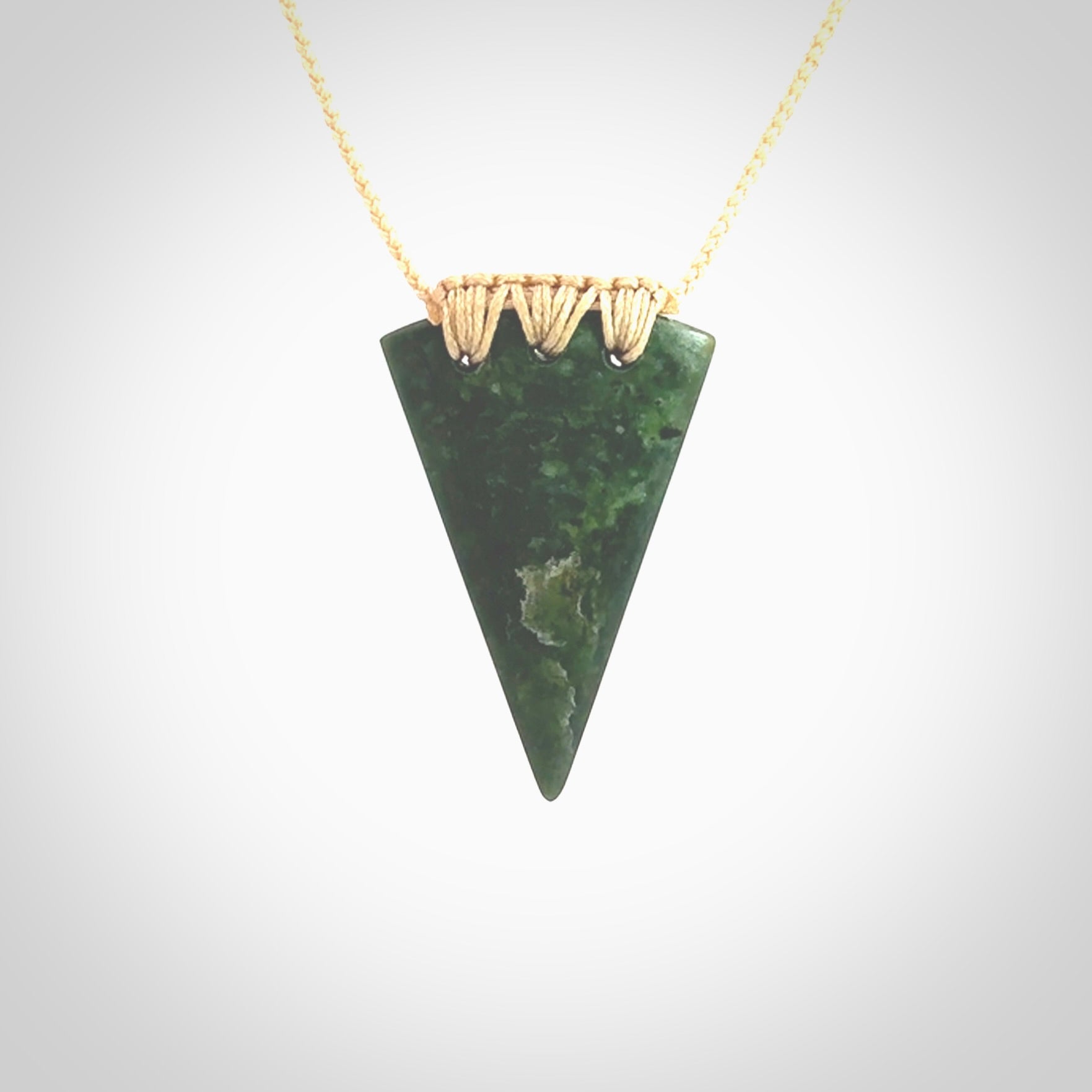 This photo shows a jade niho, drop shaped pendant. It a a lovely deep green jade. The cord is a four plait beige and is adjustable in length. One only medium, contemporary drop necklace from Jade, by Ric Moor.