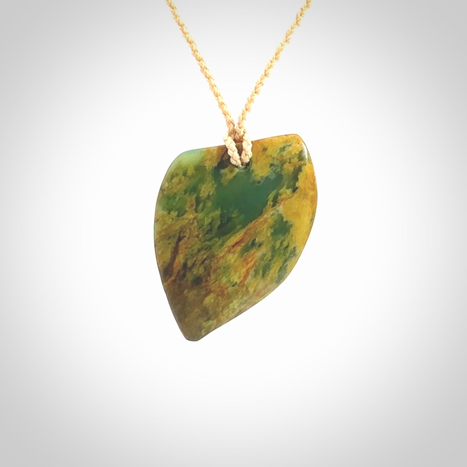 Hand carved pounamu drop pendant. Flower Jade necklace hand made in New Zealand. A contemporary drop pendant carved from rare New Zealand flower jade. NZ Pacific jade jewellery for sale online.