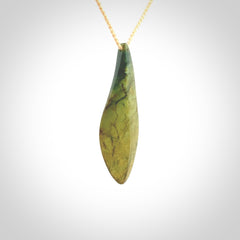 This photo shows a large flower jade drop shaped pendant. It a a lovely green and orange jade. The cord is a four plait beige and is adjustable in length. One only large, contemporary drop necklace from Jade, by Ric Moor.