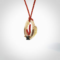 Hand carved incredible Huia bird Deer Antler Bone carving. A stunning work of art, beautifully replicating two huia birds meeting. This pendant was hand carved in Deer Antler with Red Coral by Sami. A one off collectors item that has been hand crafted to be worn or displayed.