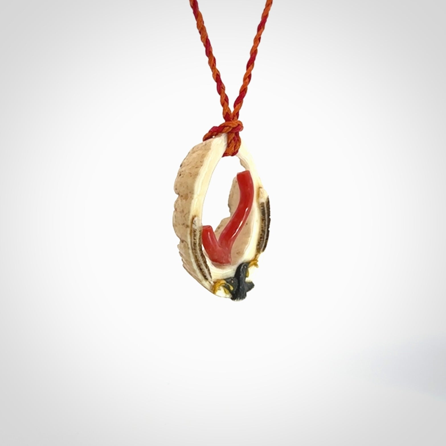 Hand carved incredible Huia bird Deer Antler Bone carving. A stunning work of art, beautifully replicating two huia birds meeting. This pendant was hand carved in Deer Antler with Red Coral by Sami. A one off collectors item that has been hand crafted to be worn or displayed.