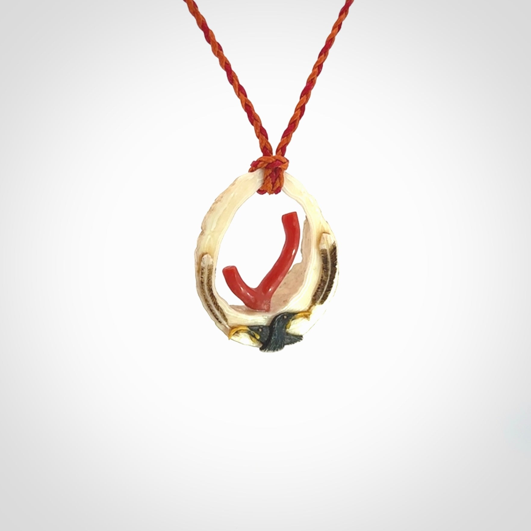 Hand carved incredible Huia bird Deer Antler Bone carving. A stunning work of art, beautifully replicating two huia birds meeting. This pendant was hand carved in Deer Antler with Red Coral by Sami. A one off collectors item that has been hand crafted to be worn or displayed.