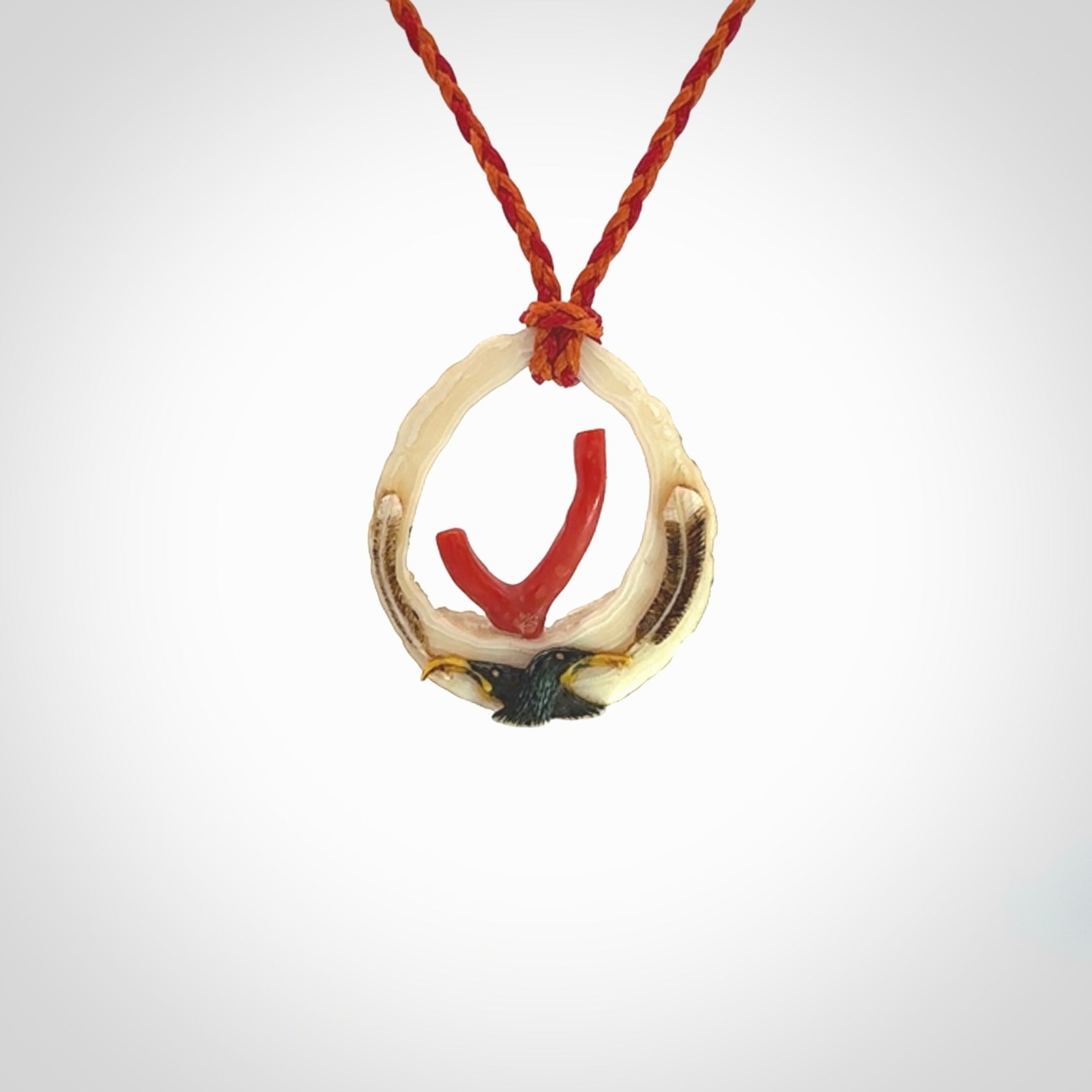 Hand carved incredible Huia bird Deer Antler Bone carving. A stunning work of art, beautifully replicating two huia birds meeting. This pendant was hand carved in Deer Antler with Red Coral by Sami. A one off collectors item that has been hand crafted to be worn or displayed.