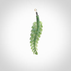 Fern Leaf Jade Stone pendant with Sterling Silver Cap. Handmade jade Fern Leaf jewellery made by NZ Pacific and for sale online. Jade stone Fern leaf pendant for men and women. Unique art to wear from NZ Pacific. Delivered on a Sterling Silver Chain.