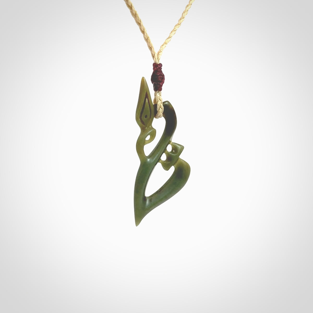 A beautiful smaller sized jade manaia pendant carved in New Zealand Jade. The pendant is suspended from a plaited oat coloured cord. The cord is length adjustable so you can position the pendant where it suits you best. One only.