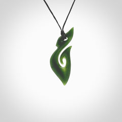 This photo shows a hook with koru pendant carved from New Zealand Jade. The artist, Shaun Gardiner, has carved this beautifully. We provide this piece with an adjustable black cord. This is a fantastic work of art, we have one only.