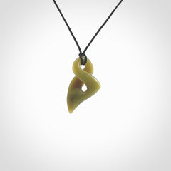 Hand carved small sized, New Zealand jade twist pendant. Carved in New Zealand by NZ Pacific. Hand made small Jade twist with adjustable black cord by Shaun Gardiner.