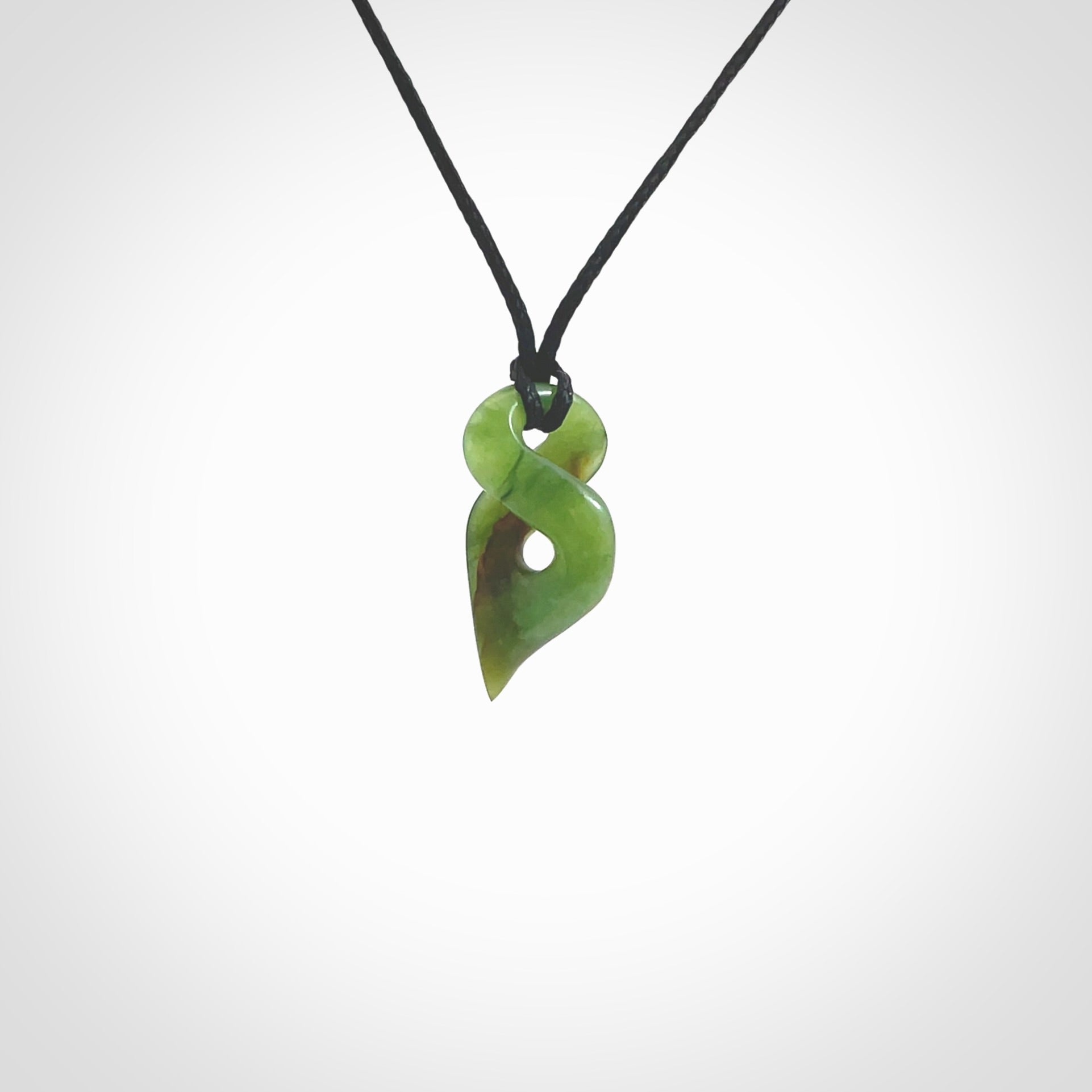 Hand carved small sized, New Zealand jade twist pendant. Carved in New Zealand by NZ Pacific. Hand made small Jade twist with adjustable black cord by Shaun Gardiner.