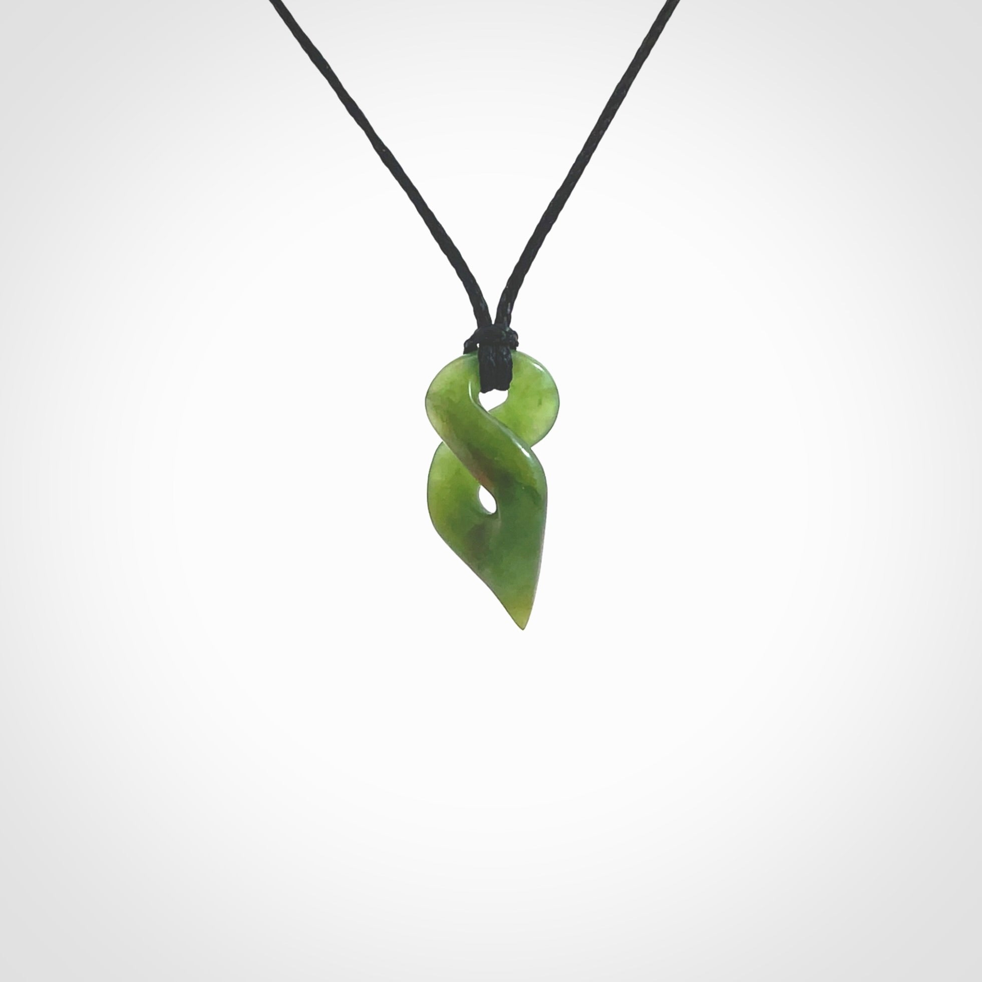 Hand carved small sized, New Zealand jade twist pendant. Carved in New Zealand by NZ Pacific. Hand made small Jade twist with adjustable black cord by Shaun Gardiner.