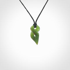 Hand carved small sized, New Zealand jade twist pendant. Carved in New Zealand by NZ Pacific. Hand made small Jade twist with adjustable black cord by Shaun Gardiner.