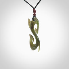 This photo shows a contemporary S shaped pendant carved from New Zealand Jade. The artist, Shaun Gardiner, has carved this beautifully. We provide this piece with an adjustable black cord. This is a fantastic work of art, we have one only.