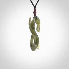 This photo shows a contemporary S shaped pendant carved from New Zealand Jade. The artist, Shaun Gardiner, has carved this beautifully. We provide this piece with an adjustable black cord. This is a fantastic work of art, we have one only.