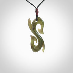 This photo shows a contemporary S shaped pendant carved from New Zealand Jade. The artist, Shaun Gardiner, has carved this beautifully. We provide this piece with an adjustable black cord. This is a fantastic work of art, we have one only.