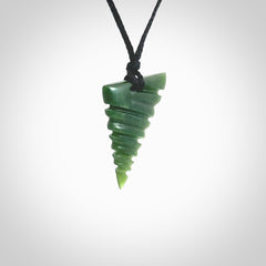 This photo shows a contemporary drop carved into New Zealand Jade. The artist, Shaun Gardiner, has carved this beautifully. We have added an adjustable black cord. This is a fantastic work of art, we have one only.