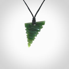 This photo shows a contemporary drop carved into New Zealand Jade. The artist, Shaun Gardiner, has carved this beautifully. We have added an adjustable black cord. This is a fantastic work of art, we have one only.