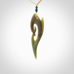 This photo shows a koru pendant carved from New Zealand Jade. The artist, Shaun Gardiner, has carved this beautifully. We provide this piece with an adjustable oat coloured cord. This is a fantastic work of art, we have one only.