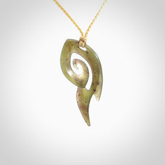 This photo shows a contemporary koru pendant carved from New Zealand Jade. The artist, Shaun Gardiner, has carved this beautifully. We provide this piece with an adjustable oat coloured cord. This is a fantastic work of art, we have one only.