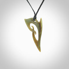 This photo shows a contemporary koru pendant carved from New Zealand Jade. The artist, Shaun Gardiner, has carved this beautifully. We provide this piece with an adjustable black coloured cord. This is a fantastic work of art, we have one only.