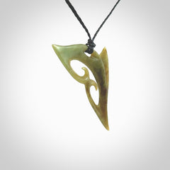 This photo shows a contemporary koru pendant carved from New Zealand Jade. The artist, Shaun Gardiner, has carved this beautifully. We provide this piece with an adjustable black coloured cord. This is a fantastic work of art, we have one only.