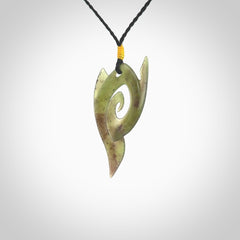 This photo shows a contemporary koru pendant carved from New Zealand Jade. The artist, Shaun Gardiner, has carved this beautifully. We provide this piece with an adjustable black coloured cord. This is a fantastic work of art, we have one only.