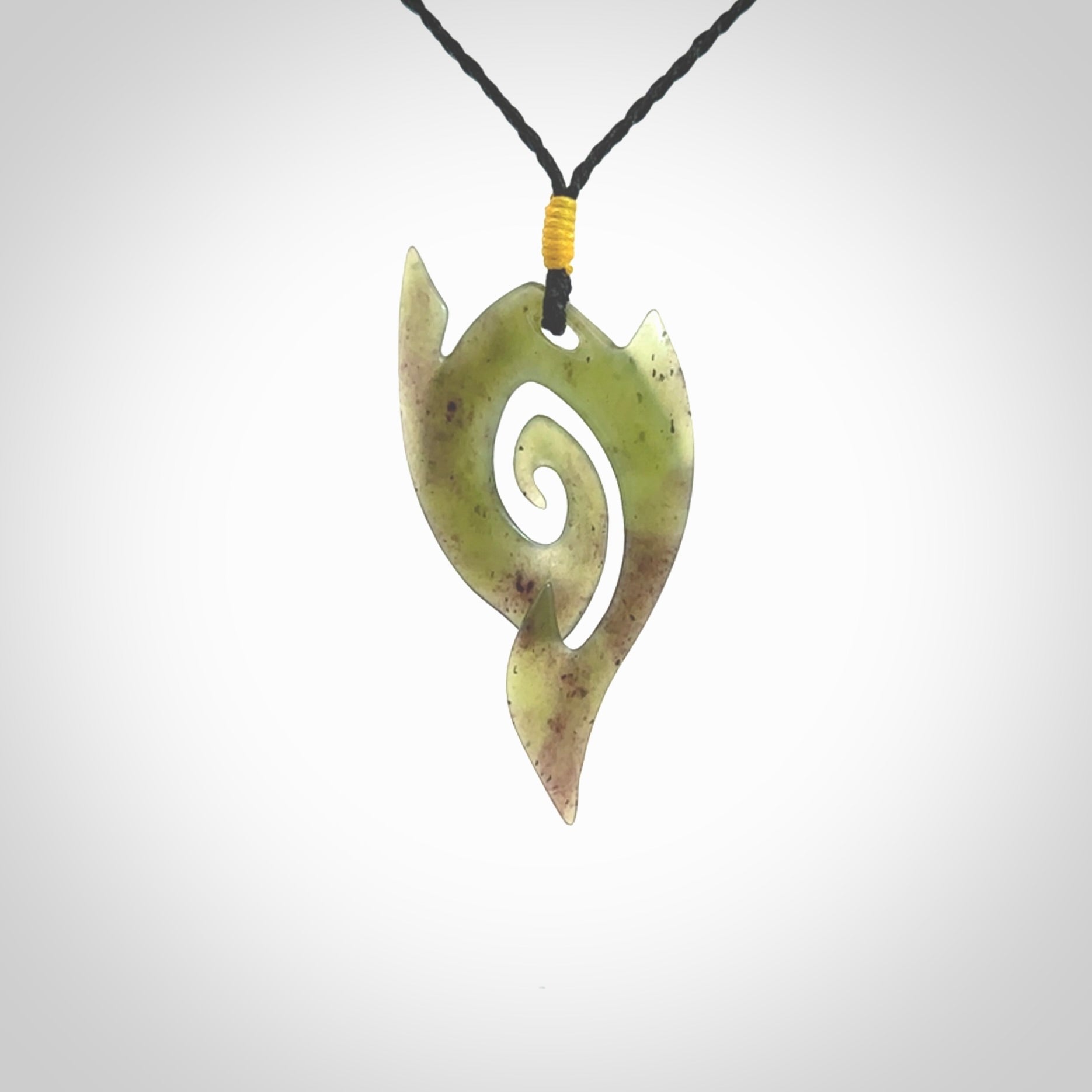 This photo shows a contemporary koru pendant carved from New Zealand Jade. The artist, Shaun Gardiner, has carved this beautifully. We provide this piece with an adjustable black coloured cord. This is a fantastic work of art, we have one only.