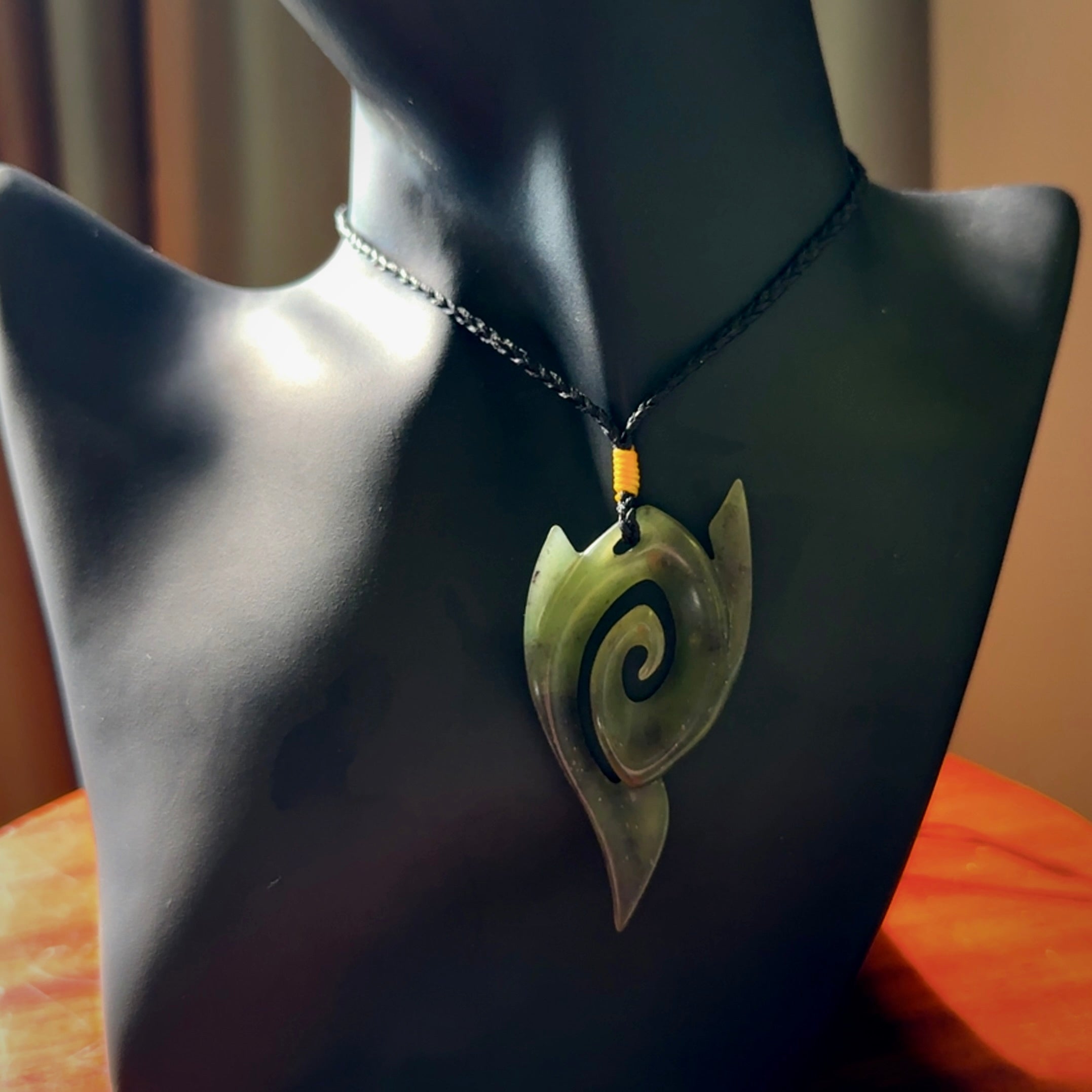 This photo shows a contemporary koru pendant carved from New Zealand Jade. The artist, Shaun Gardiner, has carved this beautifully. We provide this piece with an adjustable black coloured cord. This is a fantastic work of art, we have one only.