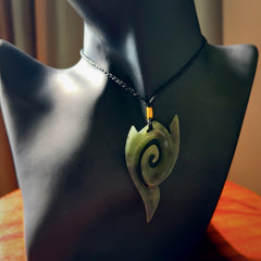 This photo shows a contemporary koru pendant carved from New Zealand Jade. The artist, Shaun Gardiner, has carved this beautifully. We provide this piece with an adjustable black coloured cord. This is a fantastic work of art, we have one only.