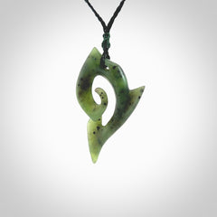 This photo shows a koru pendant carved from New Zealand Jade. The artist, Shaun Gardiner, has carved this beautifully. We provide this piece with an adjustable olive black cord. This is a fantastic work of art, we have one only.