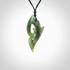 This photo shows a koru pendant carved from New Zealand Jade. The artist, Shaun Gardiner, has carved this beautifully. We provide this piece with an adjustable olive black cord. This is a fantastic work of art, we have one only.