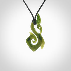 A beautiful jade manaia with koru pendant carved in New Zealand Jade. The pendant is suspended from a plaited black coloured cord. The cord is length adjustable so you can position the pendant where it suits you best. One only.