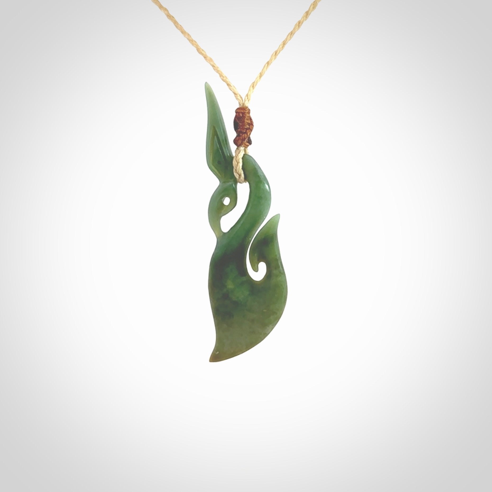 A hand carved New Zealand Jade manaia with hook pendant. Carved for us by Shaun Gardiner. One only medium sized Jade manaia necklace with adjustable cord.