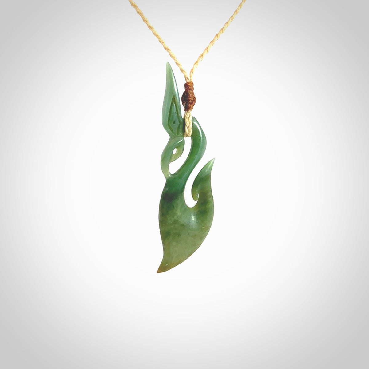 A hand carved New Zealand Jade manaia with hook pendant. Carved for us by Shaun Gardiner. One only medium sized Jade manaia necklace with adjustable cord.