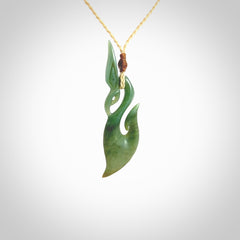 A hand carved New Zealand Jade manaia with hook pendant. Carved for us by Shaun Gardiner. One only medium sized Jade manaia necklace with adjustable cord.