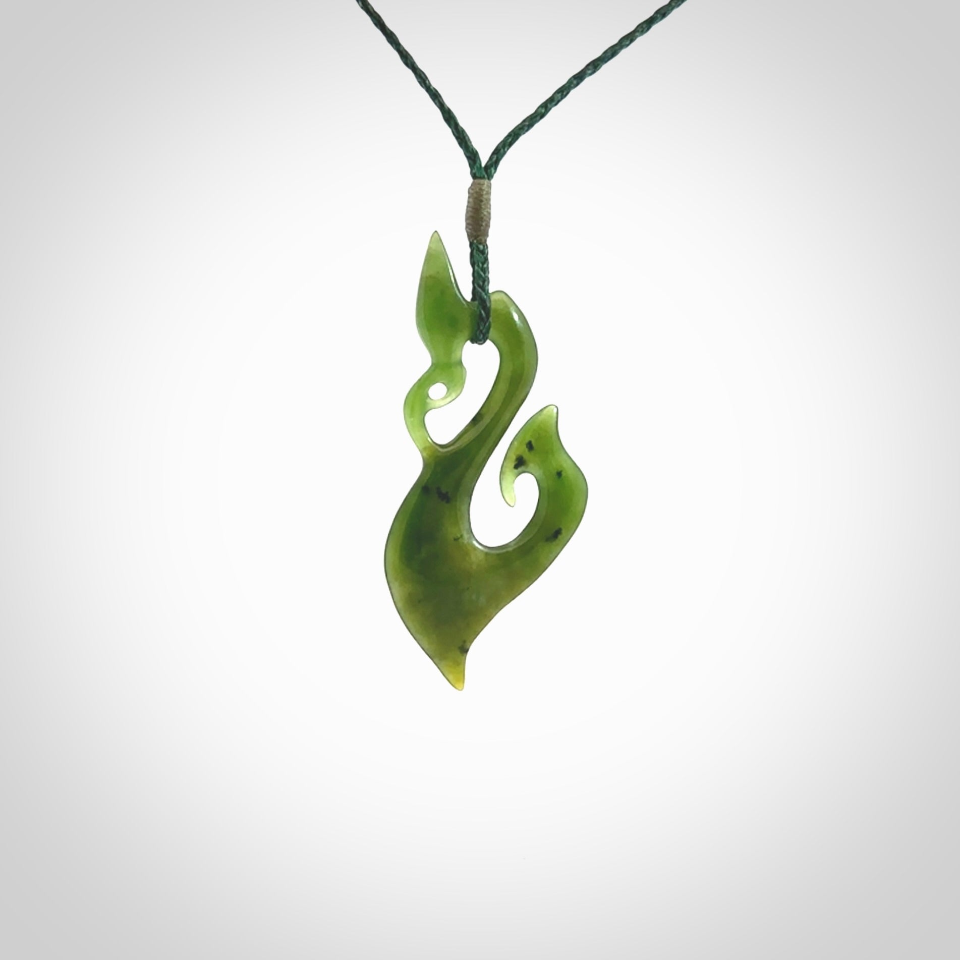 A beautiful hand carved New Zealand Jade Manaia Hook pendant with adjustable green cord. One only pendant hand made by Shaun Gardiner.