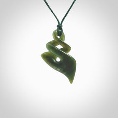 This is a striking, medium sized double twist pendant carved in New Zealand jade by Shaun Gardiner. Hand made Jade twist with adjustable green cord.