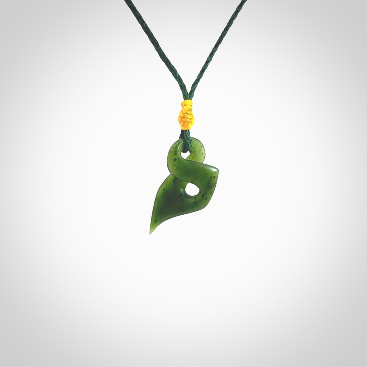 Hand carved small sized, New Zealand jade twist pendant. Carved in New Zealand by NZ Pacific. Hand made small Jade twist with adjustable green cord by Shaun Gardiner.